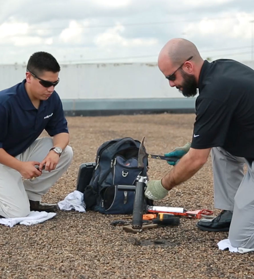 commercial roofing techs taking the core during roof inspection