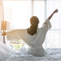 hotel guest stretching in bed 