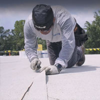 centimark roofer installing a membrane