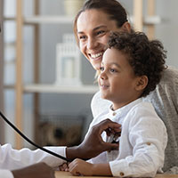 a child smiling at a doctors appointment 