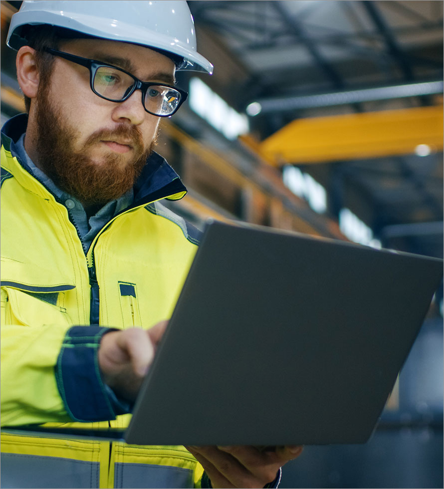 an engineer looking at a laptop