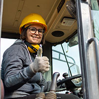 smiling crane operator shows thumbs up