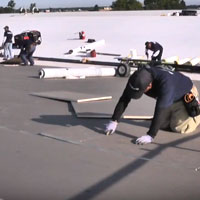 commercial roofer installing foam insulation