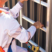 roofer climbing up a ladder